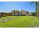 Expansive backyard with lush lawn, privacy fence, and view of the home's back exterior at 510 Shady Maple St, Moncks Corner, SC 29461