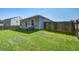 A wide-angle shot of the backyard with a lush lawn, fence, and the home's exterior at 510 Shady Maple St, Moncks Corner, SC 29461