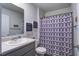 Neutral bathroom with a clean vanity, patterned shower curtain, a toilet, and decorative wall signs at 510 Shady Maple St, Moncks Corner, SC 29461