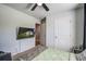 Bright bedroom featuring a comfortable bed, a mounted TV, and a view of the closet and door at 510 Shady Maple St, Moncks Corner, SC 29461
