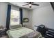 Cozy bedroom with a comfortable bed, large window with curtains, wall-mounted TV, and soft carpet at 510 Shady Maple St, Moncks Corner, SC 29461
