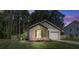 Single-story home at dusk with a brick facade, an attached garage, and a lawn at 510 Shady Maple St, Moncks Corner, SC 29461