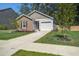 Inviting single-story home boasting a brick exterior, attached garage, landscaped yard, and lengthy driveway at 510 Shady Maple St, Moncks Corner, SC 29461