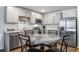 Modern kitchen with gray cabinets, granite countertops, stainless steel appliances, and dining space at 510 Shady Maple St, Moncks Corner, SC 29461