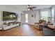 Bright living room with wood-look flooring, TV, storage, and comfortable seating with natural light at 510 Shady Maple St, Moncks Corner, SC 29461