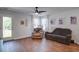 Comfortable living room with wood-look flooring, ceiling fan, recliner, and sofa with natural light at 510 Shady Maple St, Moncks Corner, SC 29461