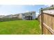 Spacious backyard with a lush green lawn, play area, and a screened-in porch perfect for outdoor living at 5138 Preserve Blvd, Ladson, SC 29456