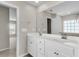 Bathroom with a large mirror over double vanity and white cabinets at 5138 Preserve Blvd, Ladson, SC 29456