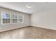 Bright bedroom featuring hardwood floors and three windows providing ample natural light at 5138 Preserve Blvd, Ladson, SC 29456