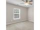 Bright, carpeted bedroom with a ceiling fan and large window with blinds at 5138 Preserve Blvd, Ladson, SC 29456