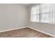 Cozy bedroom with natural light, hardwood floors, neutral paint, and a window with sheer curtains at 5138 Preserve Blvd, Ladson, SC 29456
