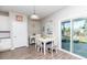 Sunlit dining area featuring a slider to the screened porch and a table set for six at 5138 Preserve Blvd, Ladson, SC 29456