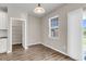 Cozy dining area with wood floors and a view to the backyard, and convenient pantry access at 5138 Preserve Blvd, Ladson, SC 29456
