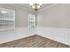 Cozy dining area featuring hardwood floors, decorative wainscoting, and natural light from two windows at 5138 Preserve Blvd, Ladson, SC 29456