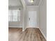 Bright entryway featuring hardwood floors, a window, and white trim, creating a welcoming ambiance at 5138 Preserve Blvd, Ladson, SC 29456