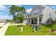 Charming two-story home with a well-maintained lawn, two-car garage, and inviting front porch at 5138 Preserve Blvd, Ladson, SC 29456