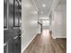 Inviting entryway with hardwood floors, neutral paint, and arched doorways leading to other rooms at 5138 Preserve Blvd, Ladson, SC 29456