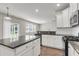 Open kitchen layout with granite countertops, white cabinets, and hardwood floors at 5138 Preserve Blvd, Ladson, SC 29456