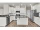 Well-equipped kitchen with white cabinets, granite counters, and stainless steel appliances at 5138 Preserve Blvd, Ladson, SC 29456
