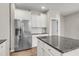 Kitchen with stainless steel fridge, white cabinets, granite counters, and center island at 5138 Preserve Blvd, Ladson, SC 29456