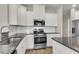 Bright kitchen features granite counters, white cabinets, and stainless steel appliances at 5138 Preserve Blvd, Ladson, SC 29456