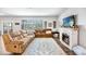 Inviting living room with a fireplace, plush sofas, and natural light from windows at 5138 Preserve Blvd, Ladson, SC 29456