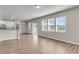 Bright living room features an open layout with natural light, hardwood floors, and neutral paint at 5138 Preserve Blvd, Ladson, SC 29456