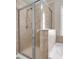 Shower with glass door, tile surround, and chrome shower head at 5138 Preserve Blvd, Ladson, SC 29456