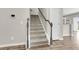Carpeted staircase with wood railing leads to the upper level at 5138 Preserve Blvd, Ladson, SC 29456