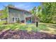 Backyard view of home featuring a screened porch, and expansive green space at 5433 Falling Tide, North Charleston, SC 29420