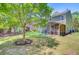 Backyard with screened porch, patio furniture, lush lawn and mature trees at 5433 Falling Tide, North Charleston, SC 29420
