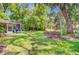 Large backyard featuring a screened porch, fire pit area and lush greenery at 5433 Falling Tide, North Charleston, SC 29420
