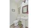 Powder room features a pedestal sink, toilet, and decorative mirror, with stylish accents and neutral tones at 5433 Falling Tide, North Charleston, SC 29420