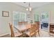 Cozy dining room with wood table and chairs, a window and sliding glass doors to the screened-in porch at 5433 Falling Tide, North Charleston, SC 29420