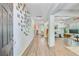 Bright entryway with hardwood floors and modern decor leading to a spacious living area at 5433 Falling Tide, North Charleston, SC 29420