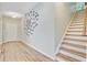 Entryway featuring hardwood flooring, staircase, front door, and artistic decorations on the wall at 5433 Falling Tide, North Charleston, SC 29420
