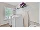 Bright laundry room featuring modern washer, dryer, shelving, and natural light from a window at 5433 Falling Tide, North Charleston, SC 29420