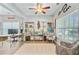 Sunlit living room features hardwood floors, a ceiling fan, and a decorative rug at 5433 Falling Tide, North Charleston, SC 29420