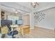 Open-concept home office with custom desk and shelving, seamlessly blending into the living space at 5433 Falling Tide, North Charleston, SC 29420