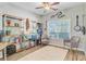 Cozy room with a ceiling fan, natural light, and comfortable seating, perfect for a music room or office at 5433 Falling Tide, North Charleston, SC 29420