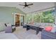 Inviting screened porch with cozy furniture, ceiling fan, and access to the dining room at 5433 Falling Tide, North Charleston, SC 29420