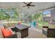 Relaxing screened porch with comfortable seating, ceiling fan, and views of the backyard at 5433 Falling Tide, North Charleston, SC 29420