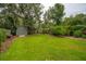 Lush backyard featuring a green shed surrounded by trees at 614 Beauregard St, Charleston, SC 29412
