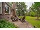 Brick home featuring a backyard patio with a fire pit and lush landscaping at 614 Beauregard St, Charleston, SC 29412