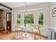 Cozy breakfast nook with modern lighting, a round table and a view of the outdoor greenery at 614 Beauregard St, Charleston, SC 29412