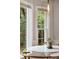 Close-up view of a breakfast nook that is accented by large windows and modern lighting at 614 Beauregard St, Charleston, SC 29412