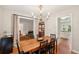 Dining room offers hardwood floors, a chandelier and view into the living room and kitchen at 614 Beauregard St, Charleston, SC 29412