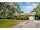A beautiful home with a brick exterior, a well-maintained yard, and an attached garage on a sunny day at 614 Beauregard St, Charleston, SC 29412