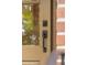 Close up of a front door with glass and black hardware, set in a red brick wall at 614 Beauregard St, Charleston, SC 29412