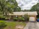 Charming single-story brick home features a well-maintained front yard and attached garage at 614 Beauregard St, Charleston, SC 29412
